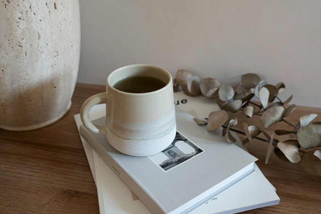 Cozy reading corner with books and a cup of tea