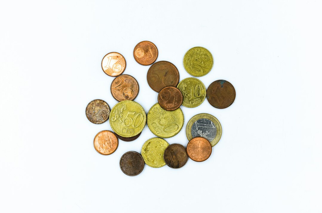 Old coins in a collector tray with a magnifier