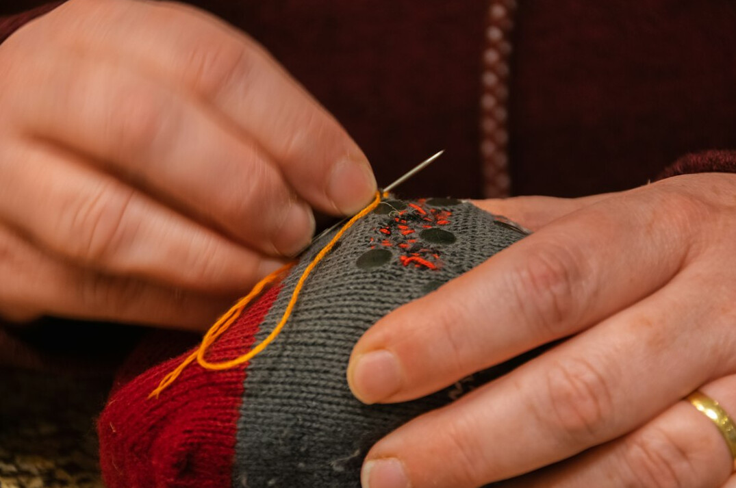person doing hand embroidery