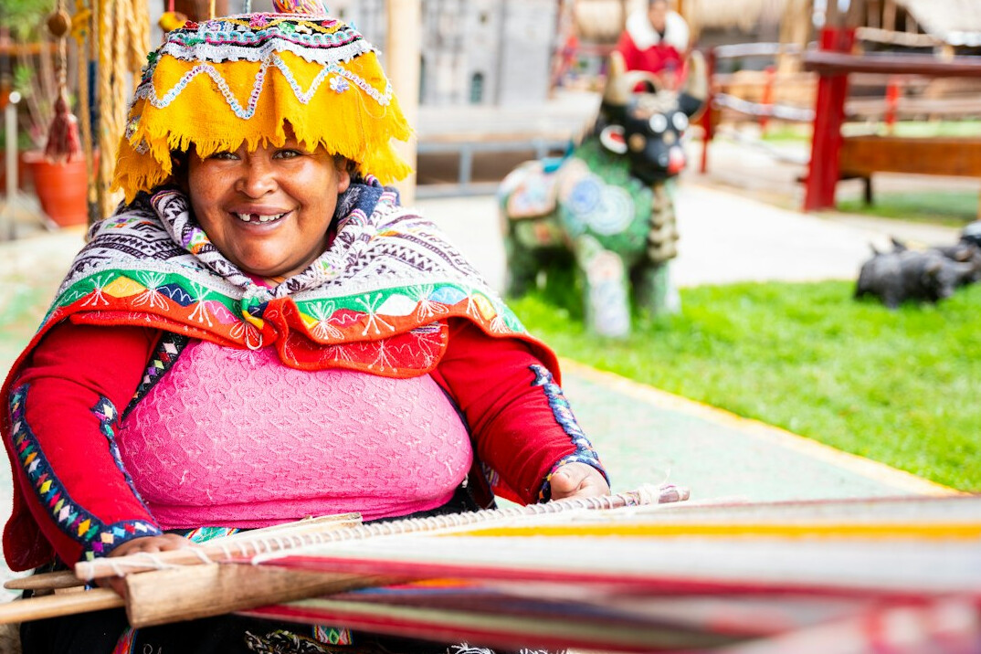 woman weaving on wooden loom