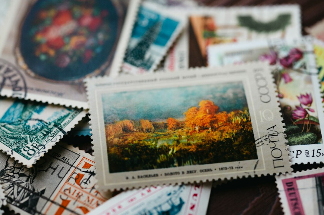 person sorting stamps