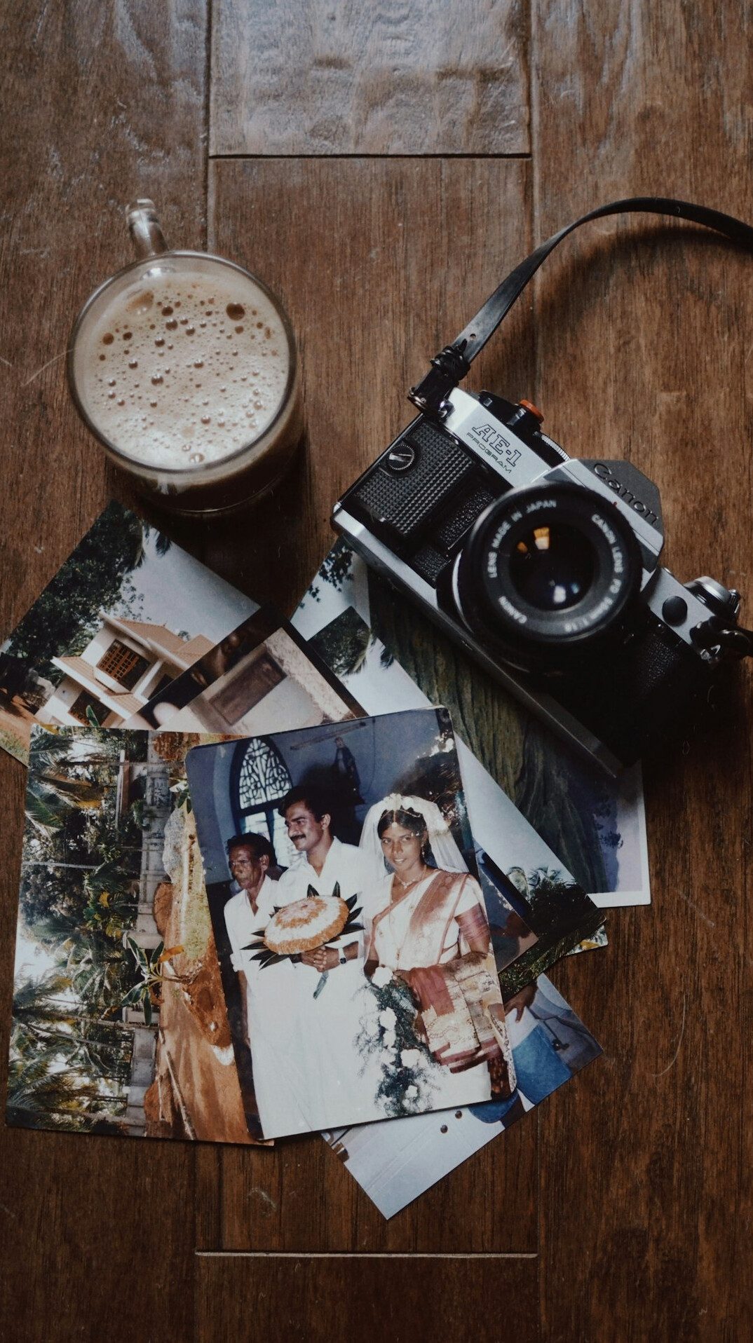 Film camera and printed photographs on a table